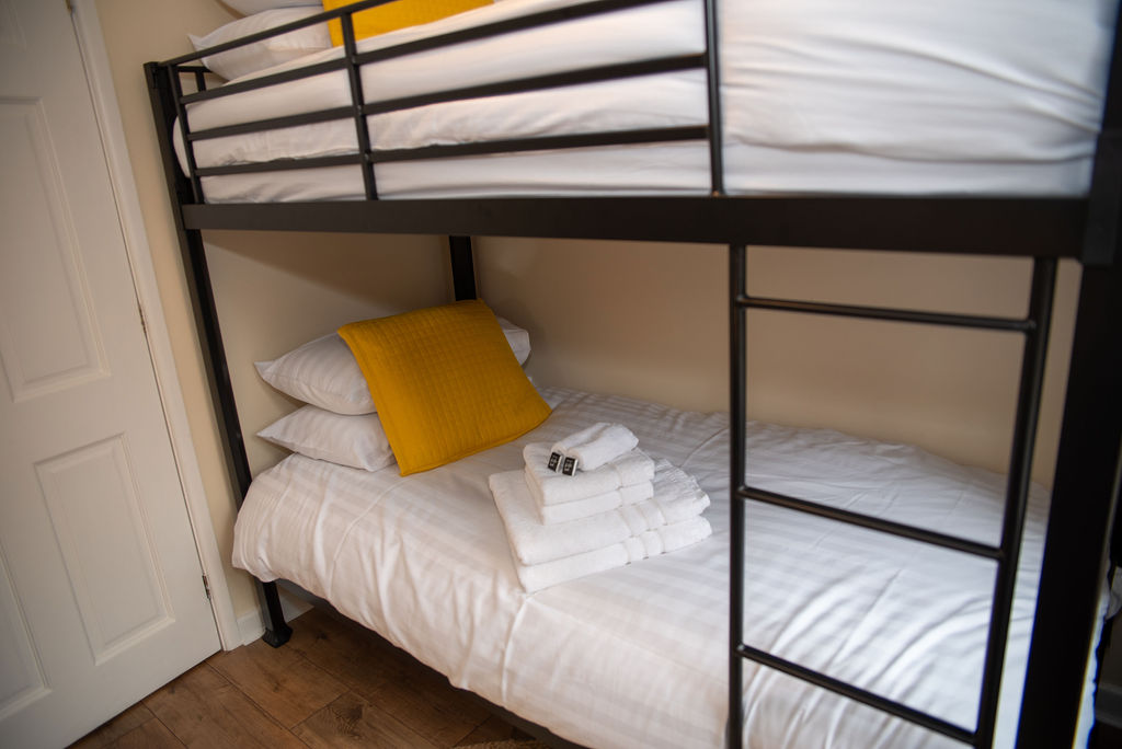 Bedroom 4 bunk beds close-up with towels and toiletries
