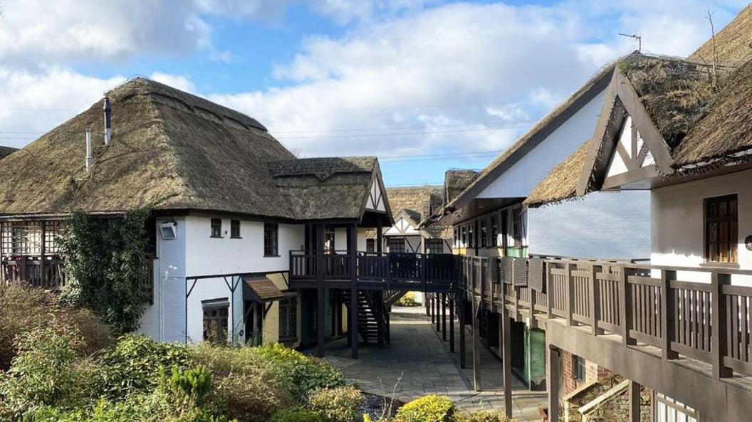 The thatched buildings and walkways of Guy's Thatched Hamlet courtyard