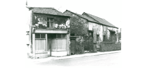Here we see the Tithebarn and the adjacent shop with bow window. The Tithebarn is fully intact but in a state of poor repair.