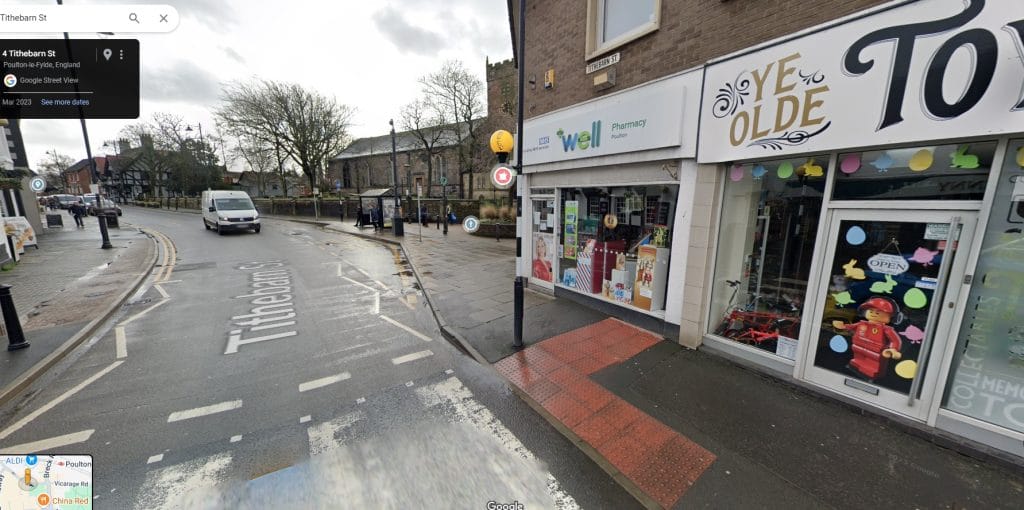 The Well Pharmacy in Poulton, with the church just visible behind